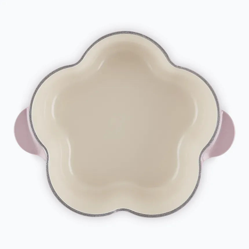 The flower casserole with the lid off, showing the petal-shaped pale enamel interior