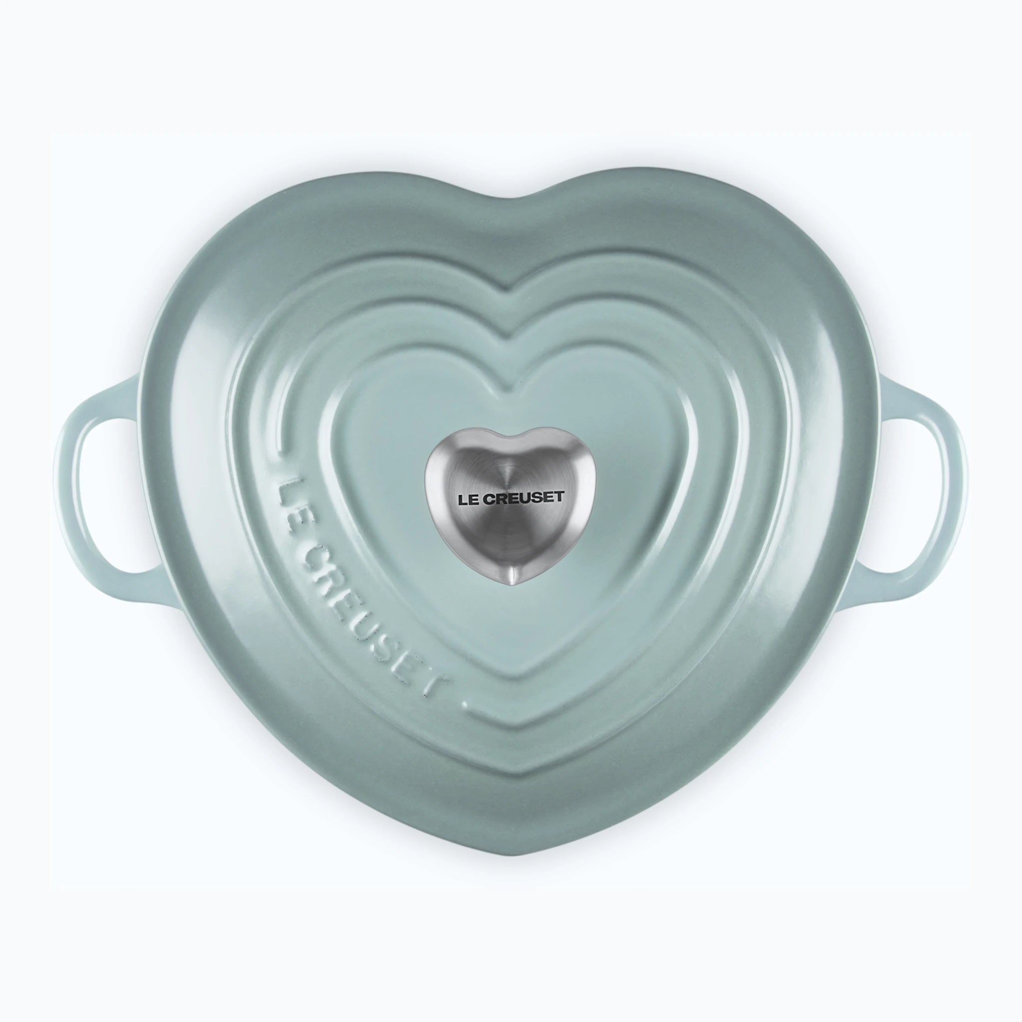 The heart casserole from directly above, showing the raised heart rings on the lid and the steel heart knob at the centre