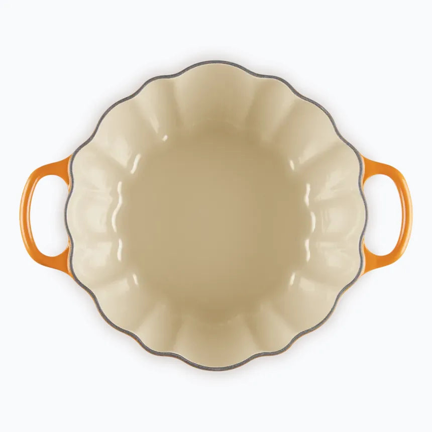 The pumpkin casserole with the lid off, showing the scalloped pale enamel interior