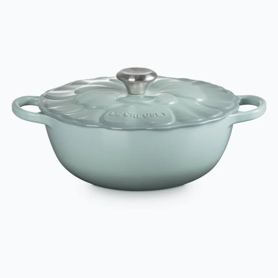 Cast iron petal soup pot in sea salt green, with an anemone pattern embossed on the lid